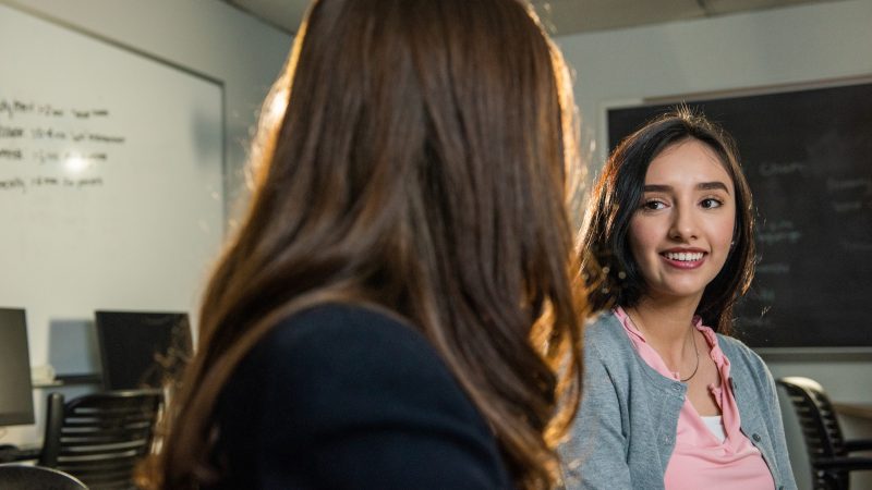 Students networking with each other in the business college.