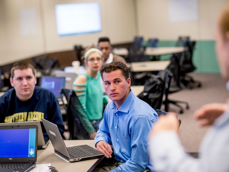 Students listening inside a business class in The W A Franke building.