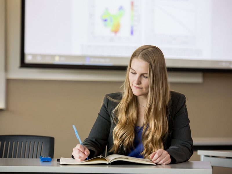 Student studying in a conference room.