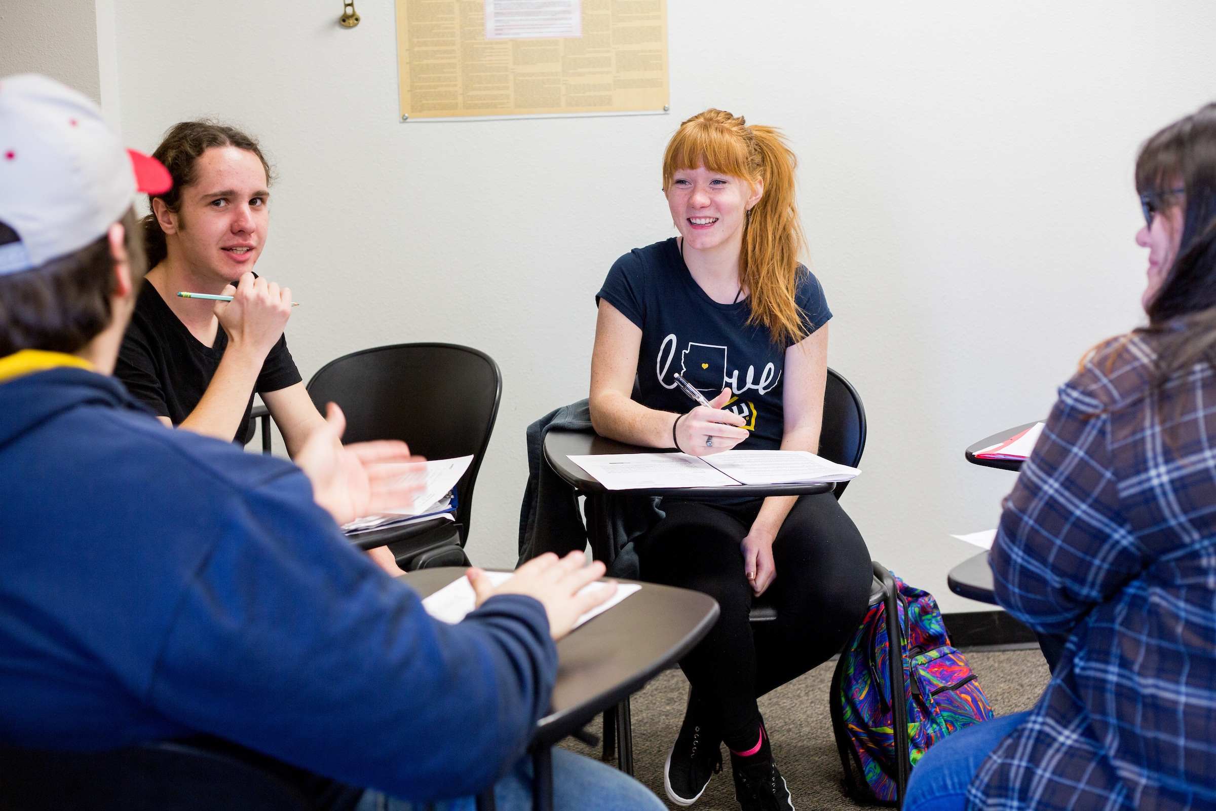 Students working together at separate desks.