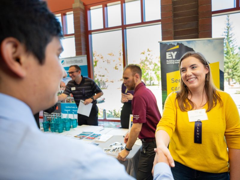 People shaking hands at Career Exploration Day.