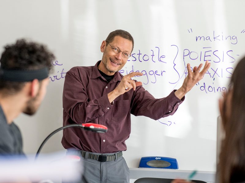 A professor describing what is on the board.