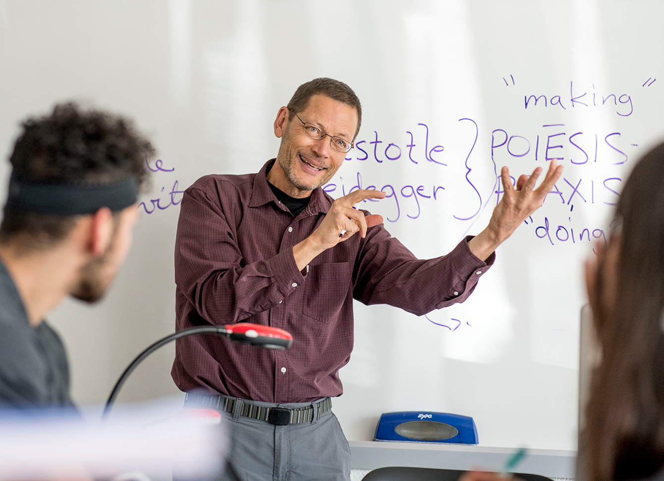 A professor describing what is on the board.