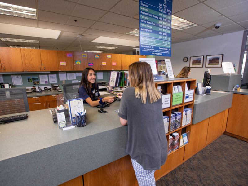 Student inquiring about parking and accessibility at the Parking Services Office at N A U.