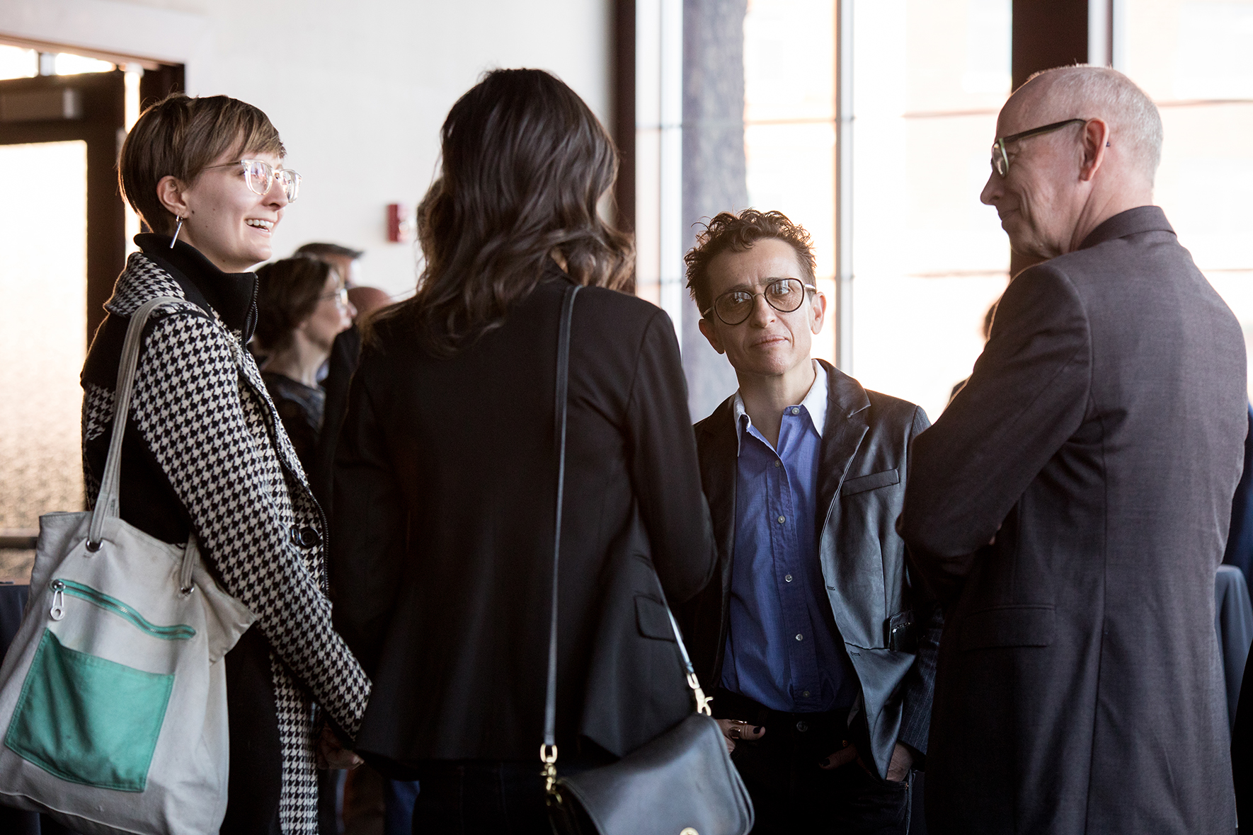 Students and professors chatting at a reception.