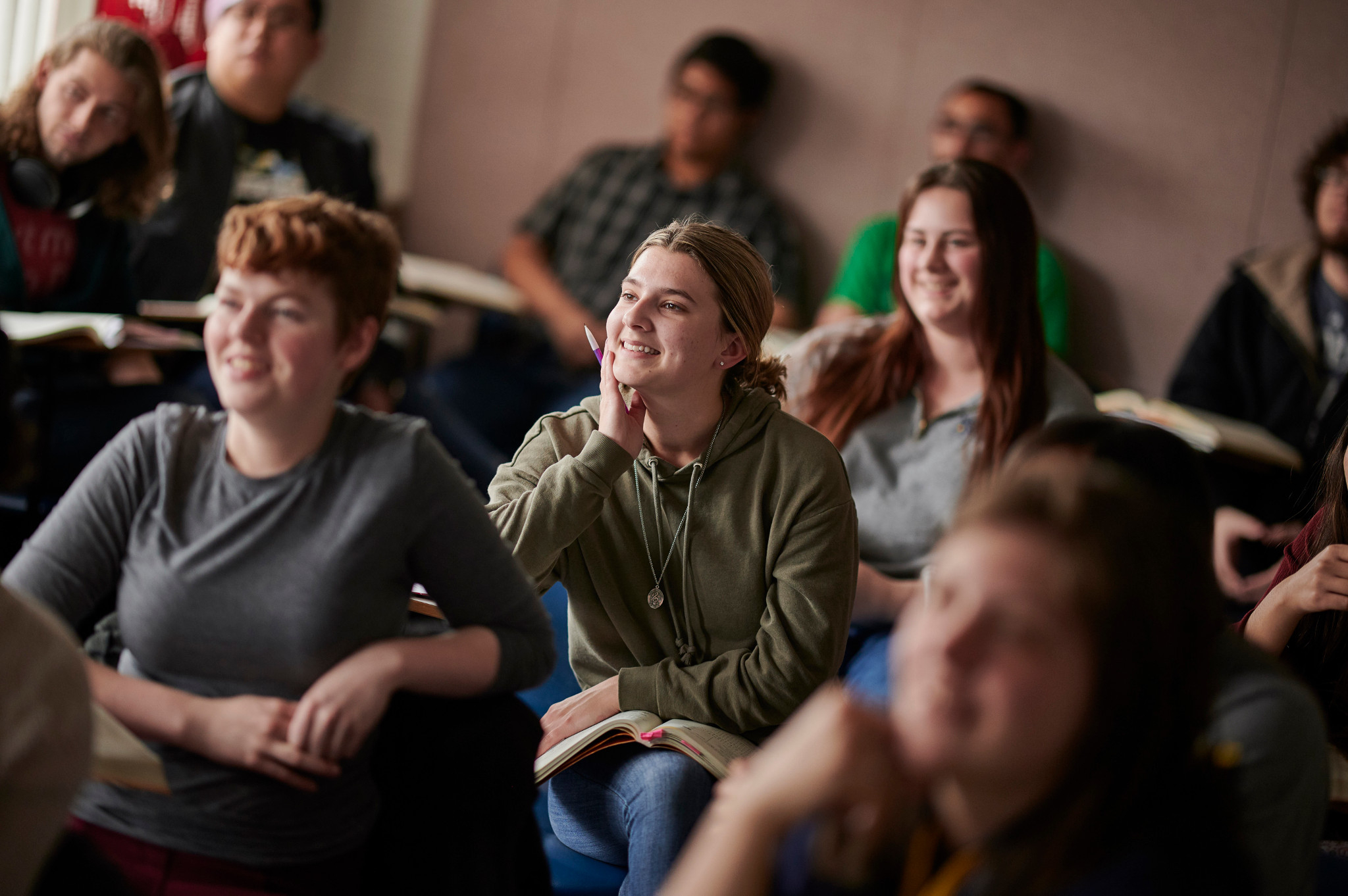 Students sitting in a linguistics class smiling.