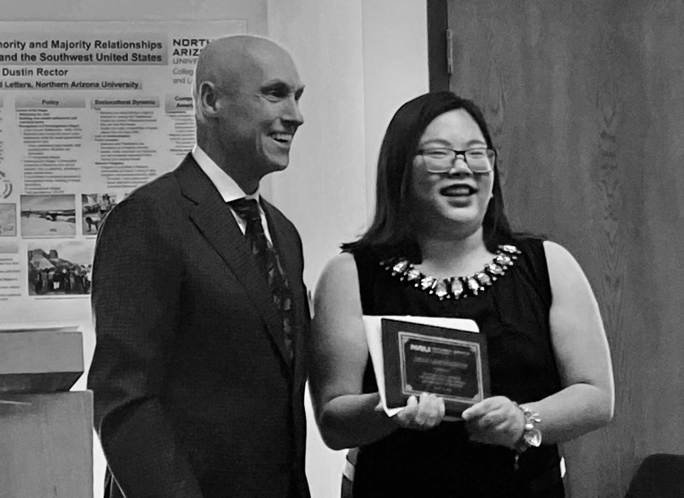 Chanamon Lerdnitisethm, outstanding graduate from the Department of History, accepts their award from Dean Boyer the morning of commencement in the Riles Building