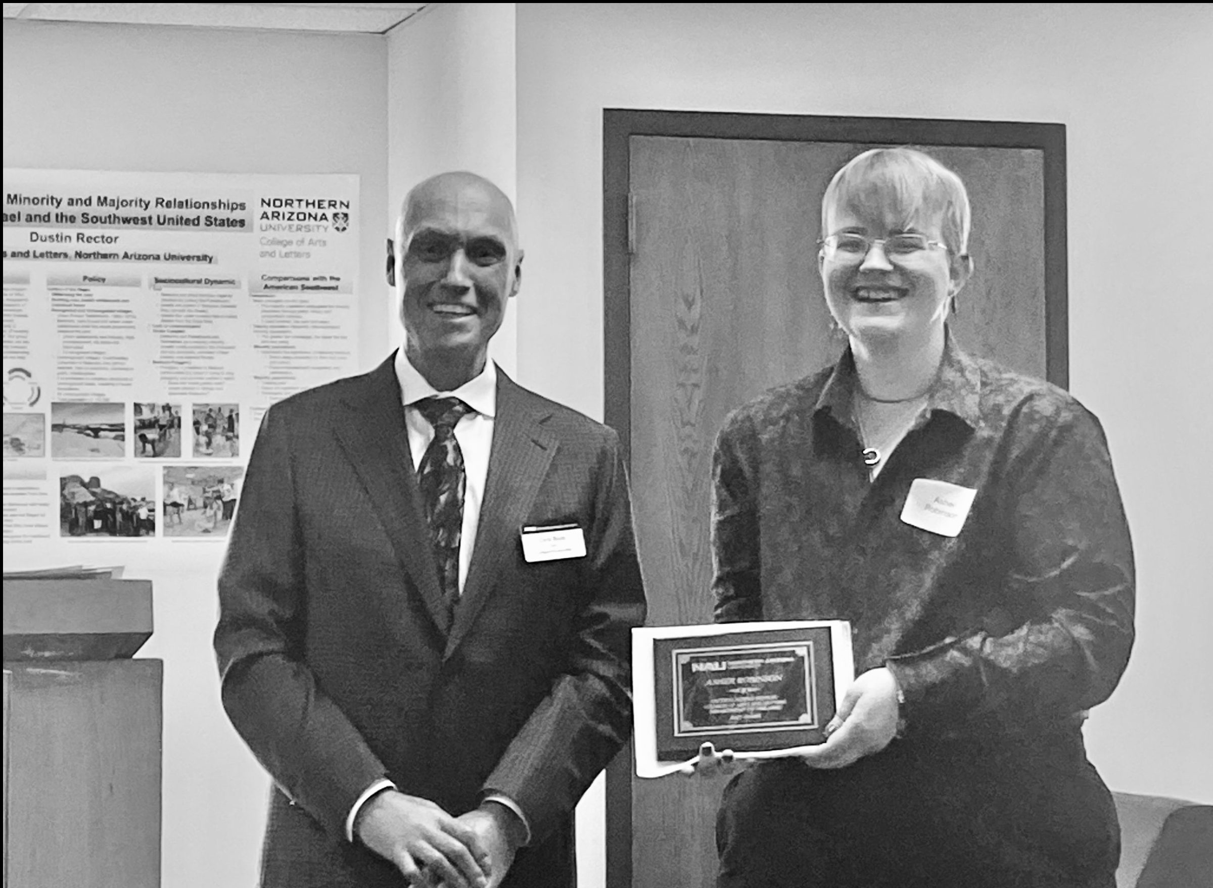 Asher Robinson accepts their award from Dean Boyer on the morning of Commencement in the Riles Building