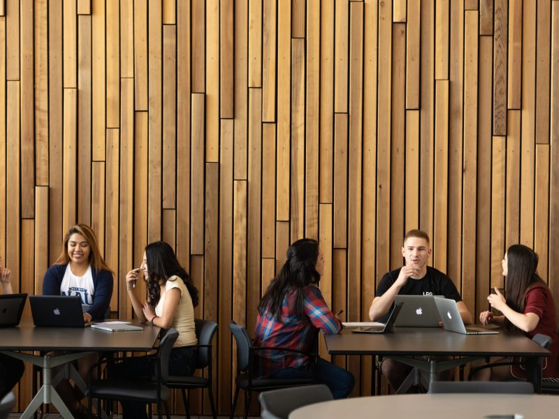 Students gathered in a study area with laptops.