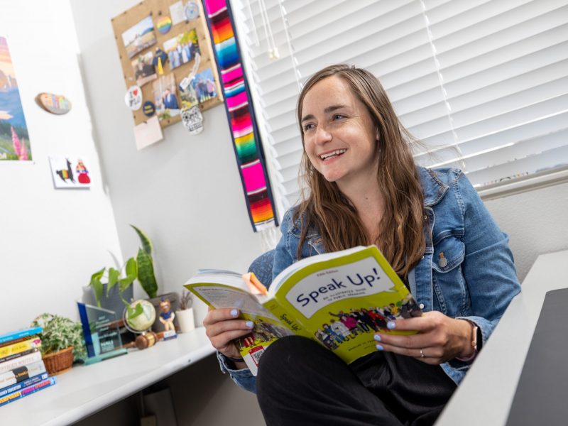 McKenzie McLoughlin reads a book called "Speak Up!" in their office.