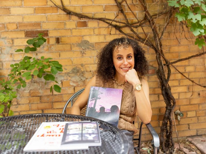 Merryman poses with her magazine outside of late for the train in Flagstaff.