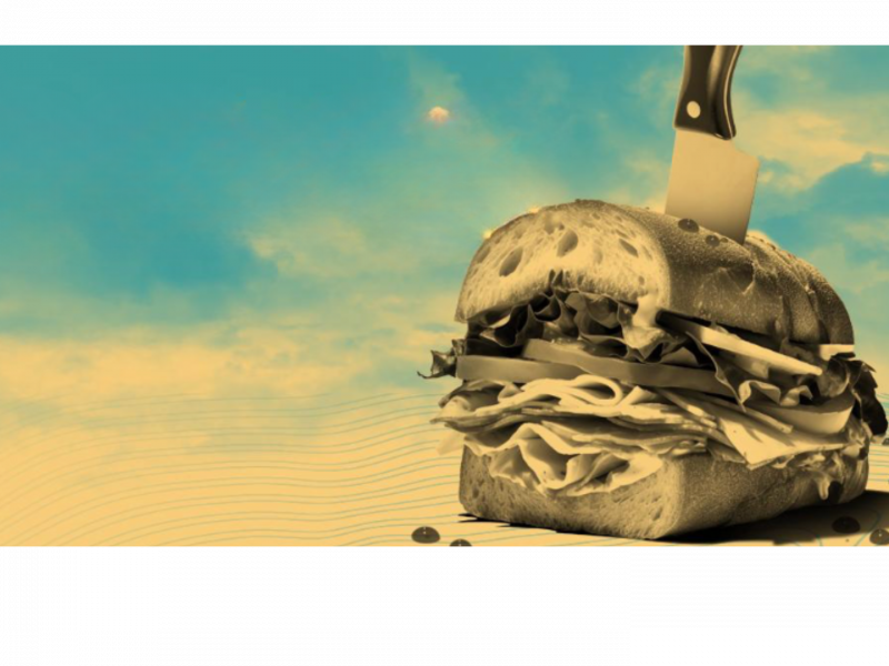 sandwhich with knife in it on blue background