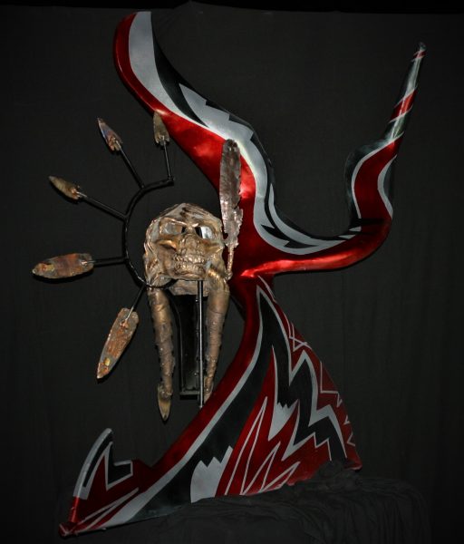 A bronze and metal sculpture of a skull and feathers called "Warrior's Way."