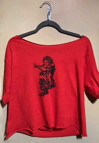 A red cropped T-shirt on a hanger.