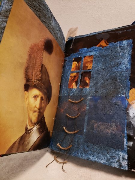 3D book art showing a rope ladder dangling from a window.