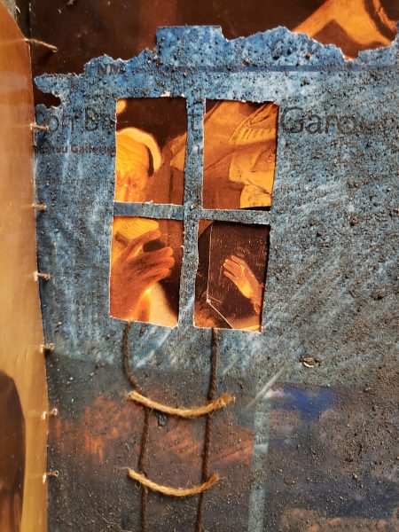 3D book art showing a rope ladder dangling from a window.