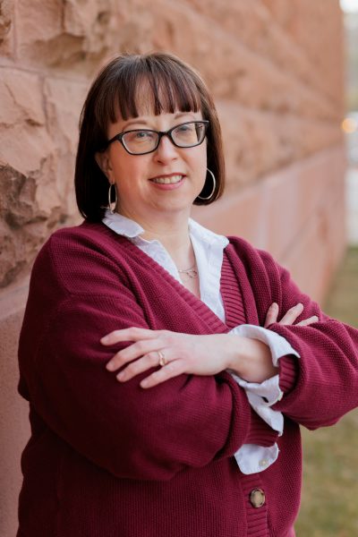 Becky Pratt-Sturges in a red sweater with her arms folded.