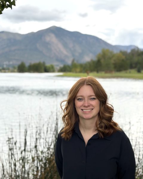 Tess McCoy in front of a lake and mountain