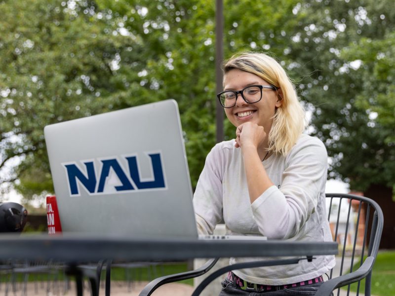 An N A U Online student works from their laptop.