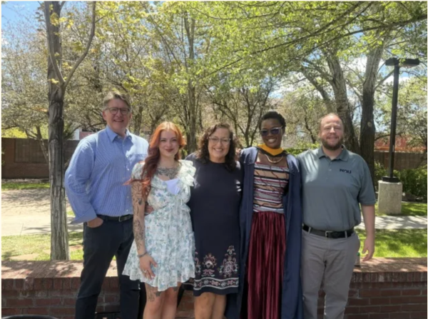 Professors and graduates pose