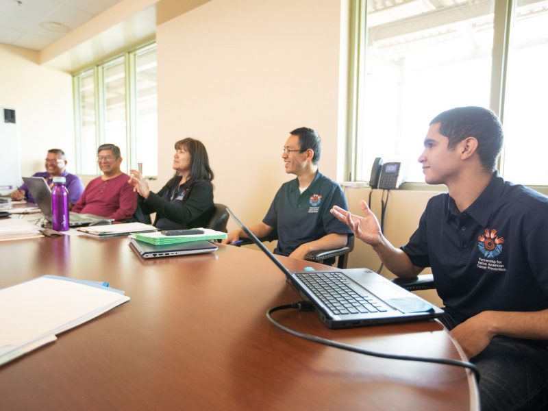 Student conversing with each other at a table.