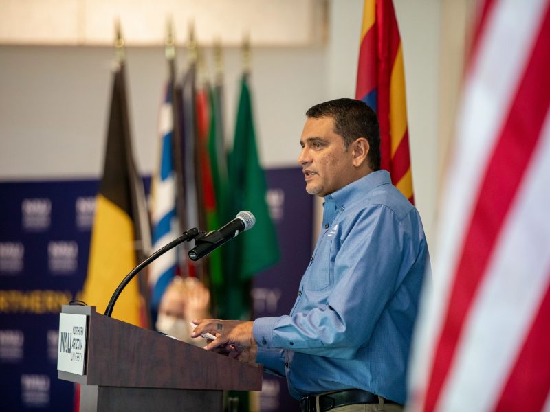 N A U president giving a speech.