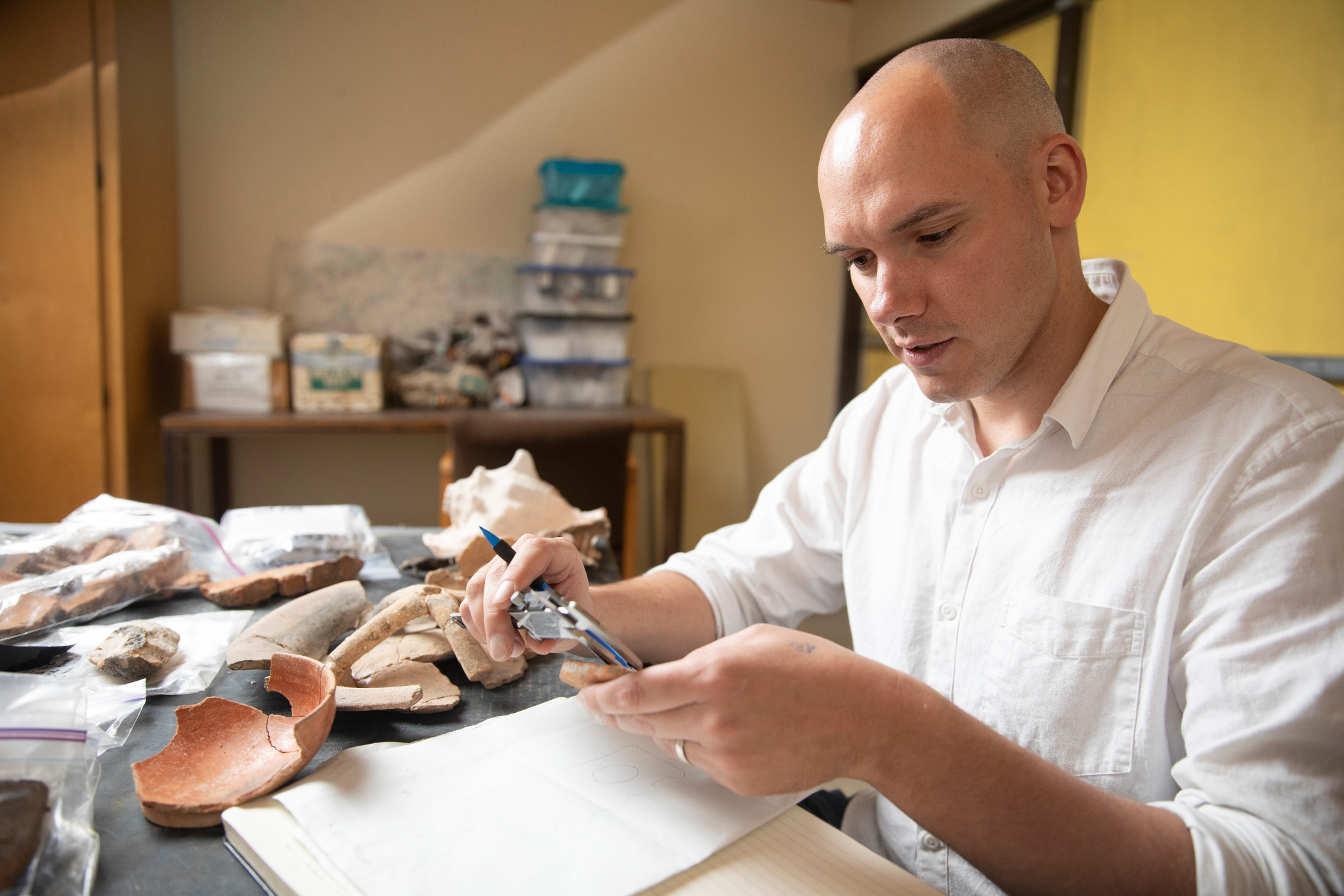 N A U student inspecting ancient artifacts.