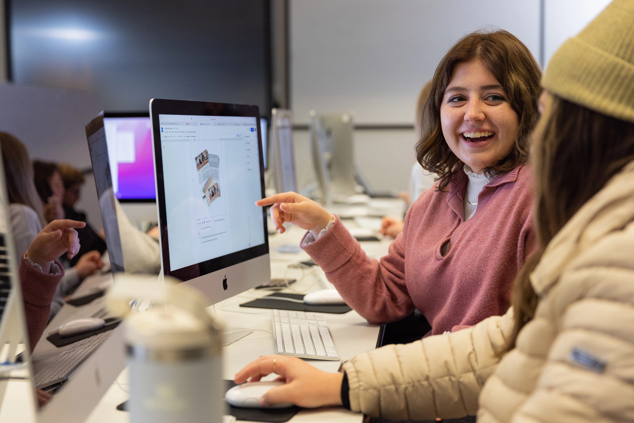 Two N A U students working on computers in the computer lab.