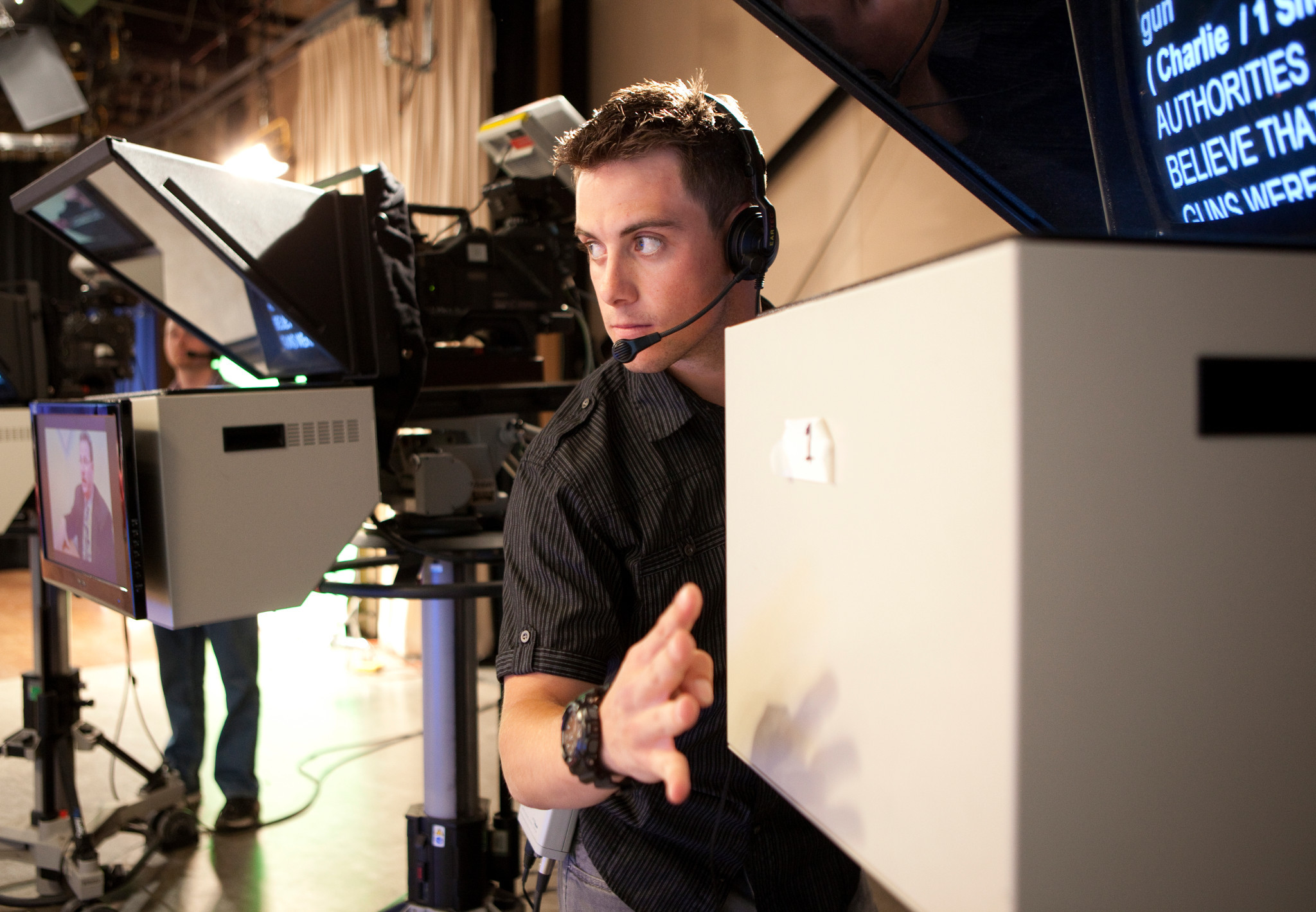 N A U Communications student giving a countdown before tv show goes live.