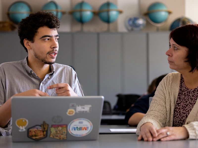 Student speaking with faculty member.