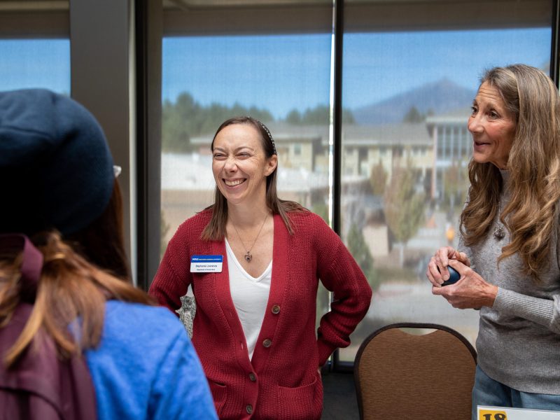 Faculty discussing at a table.