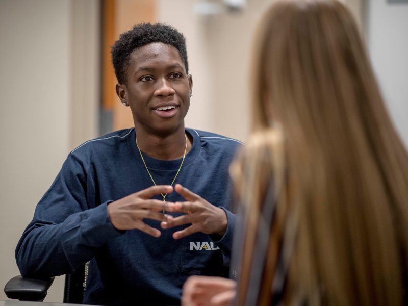 Student discussing with another student.