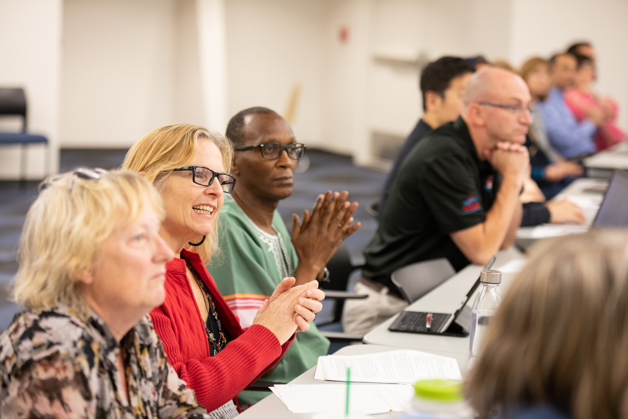 Faculty having a meeting at a table.