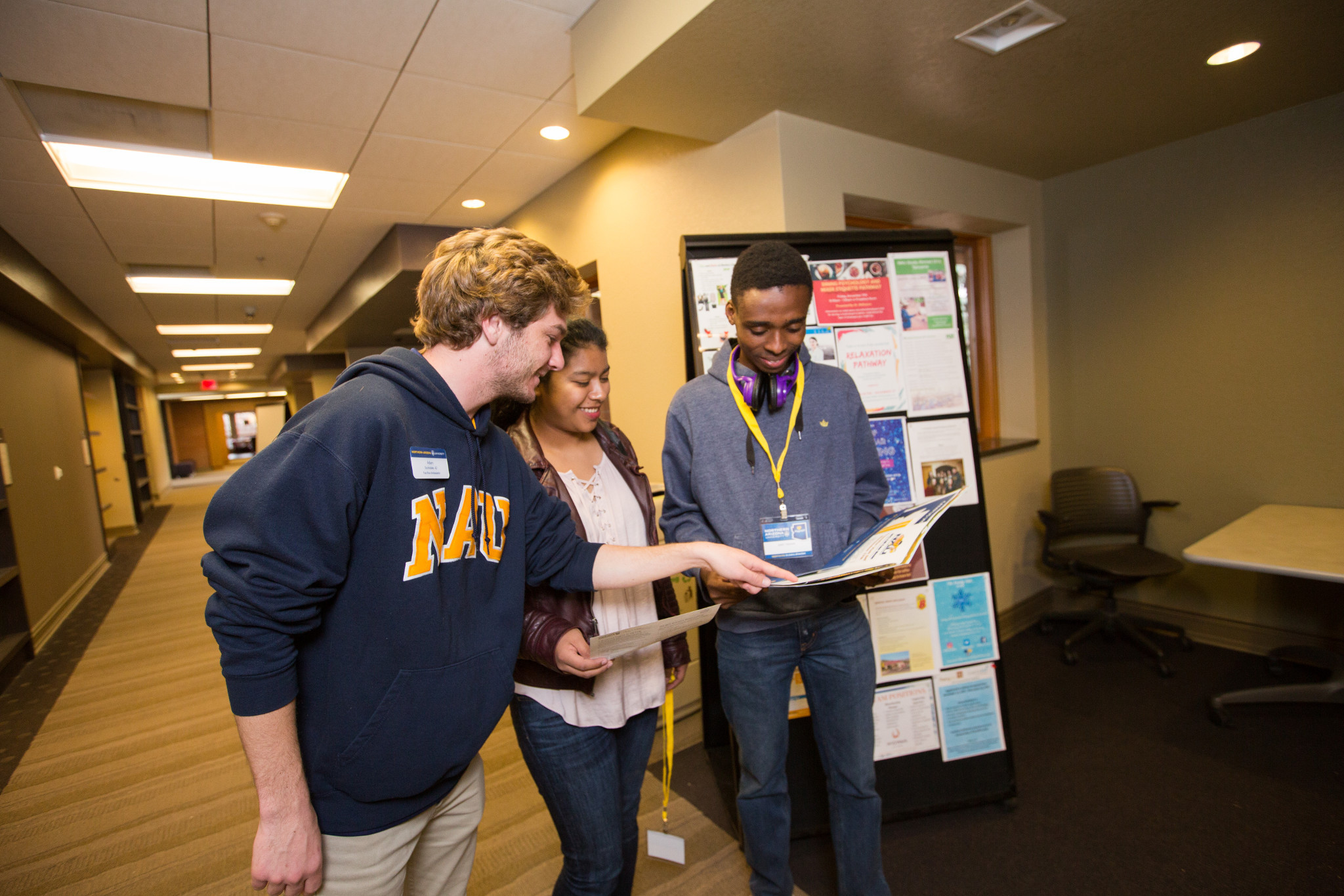 Students looking at a book together.