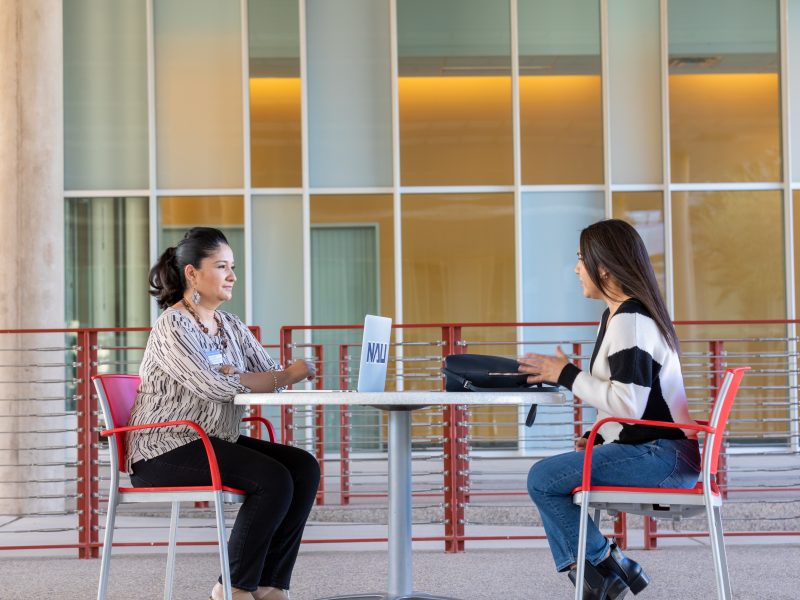 Student being interviewed by faculty member.
