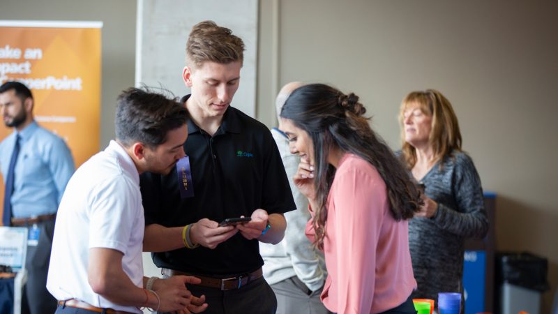 Students looking at one of the student's phone.