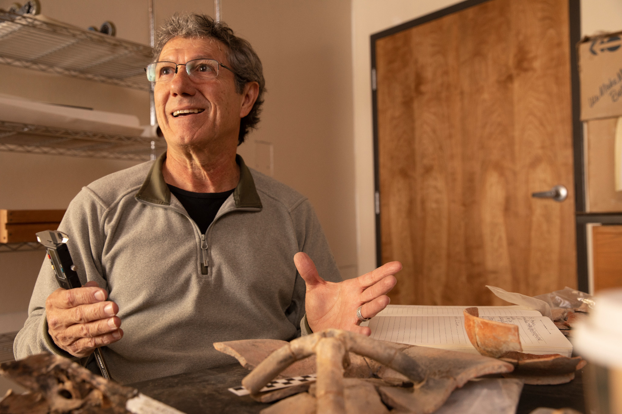 Faculty member smiling in classroom.