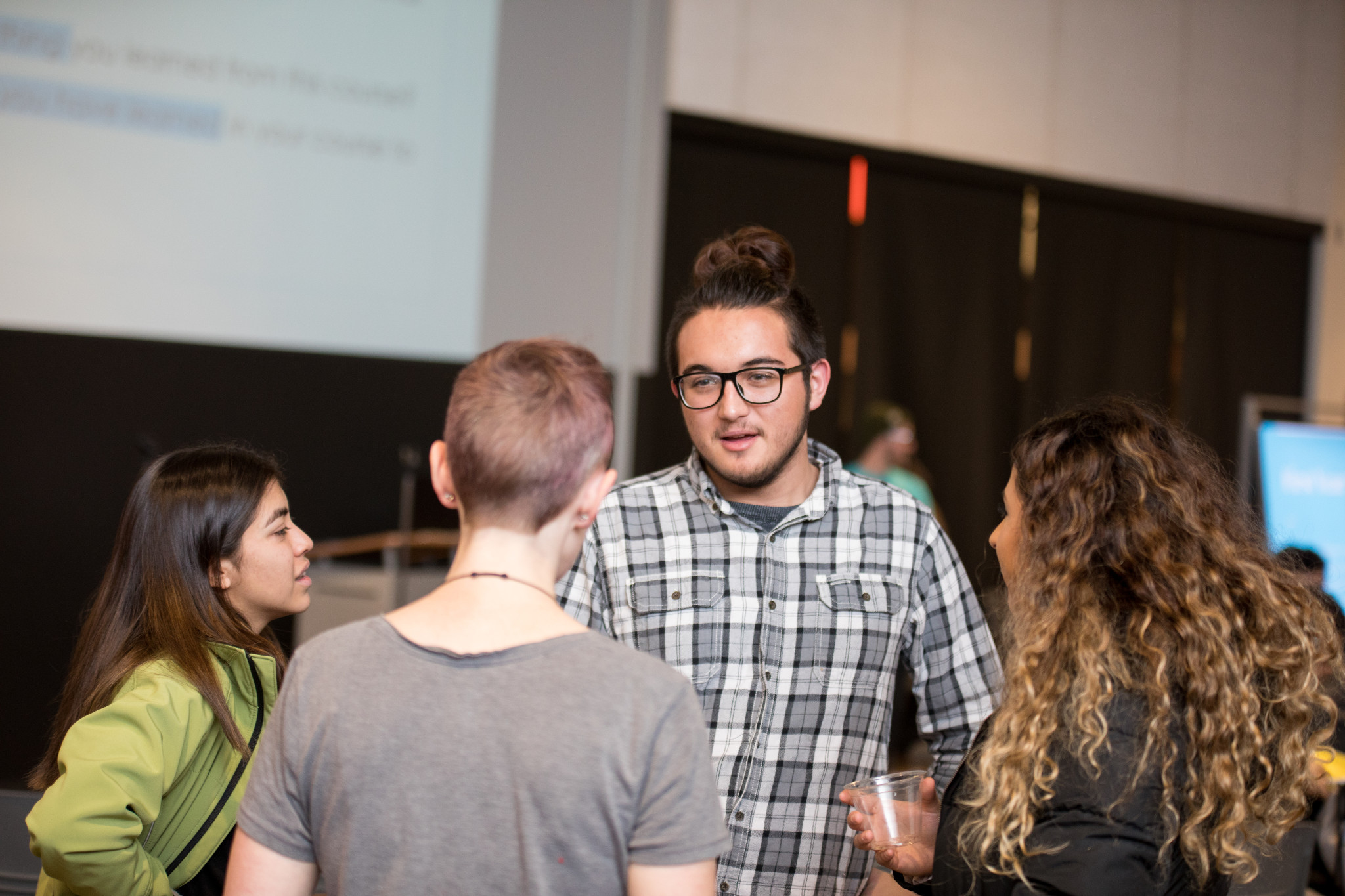 Group of students speaking to each other.