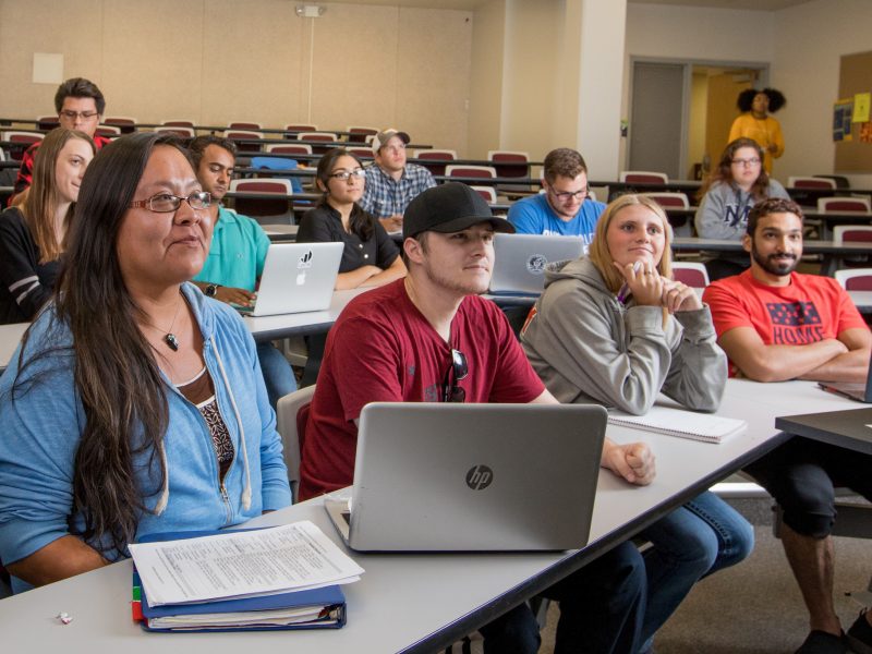 Students in classroom listening to lecture.
