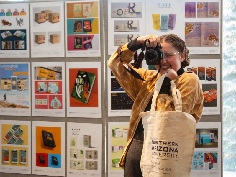 Student holding camera.