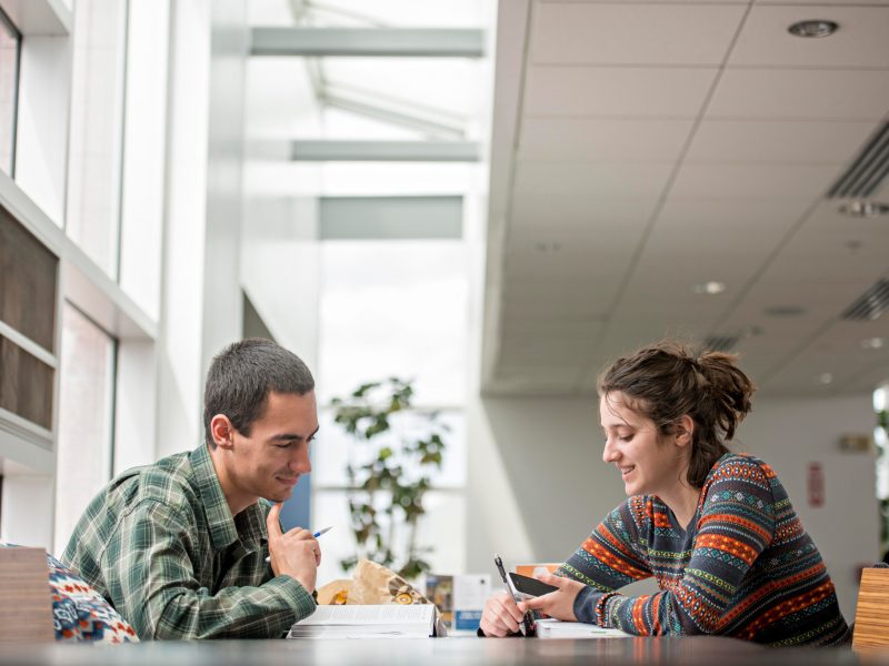 Students working together on a table.