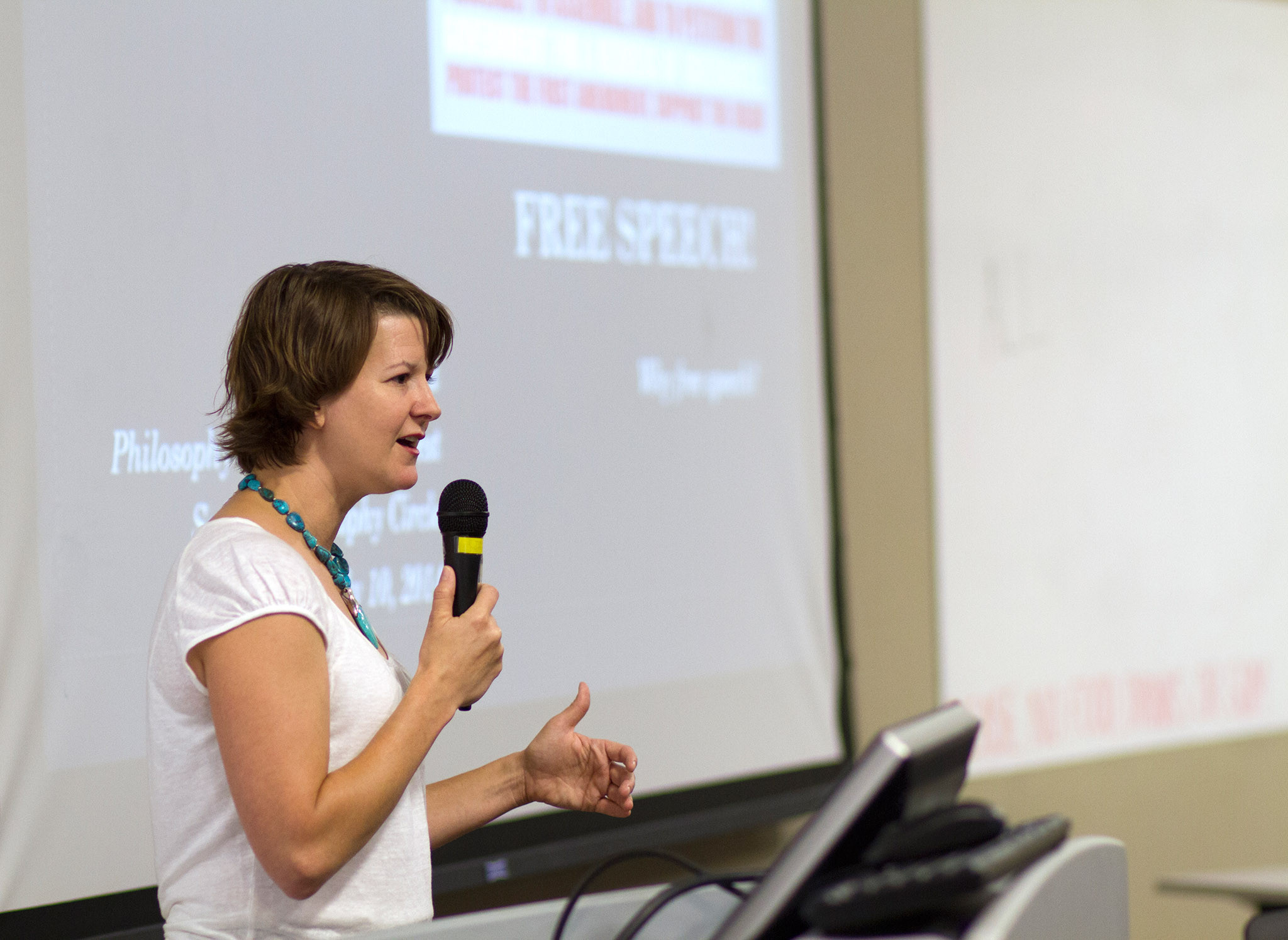 Professor speaking in front of an audience.