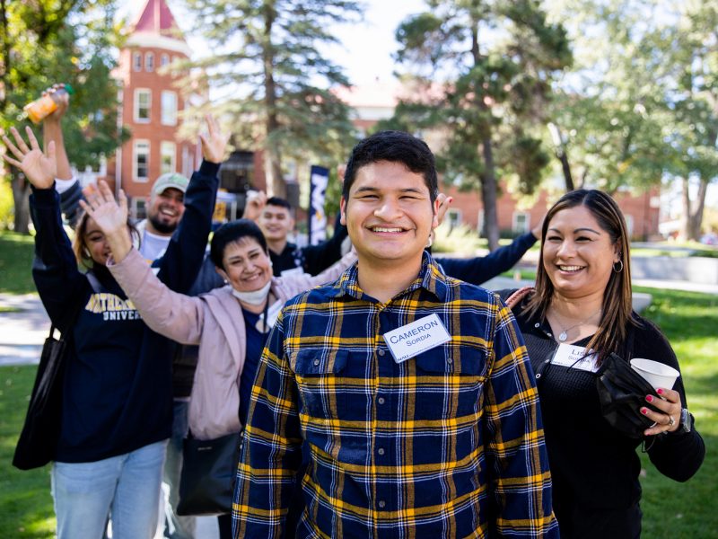 Student and family celebrating on campus.