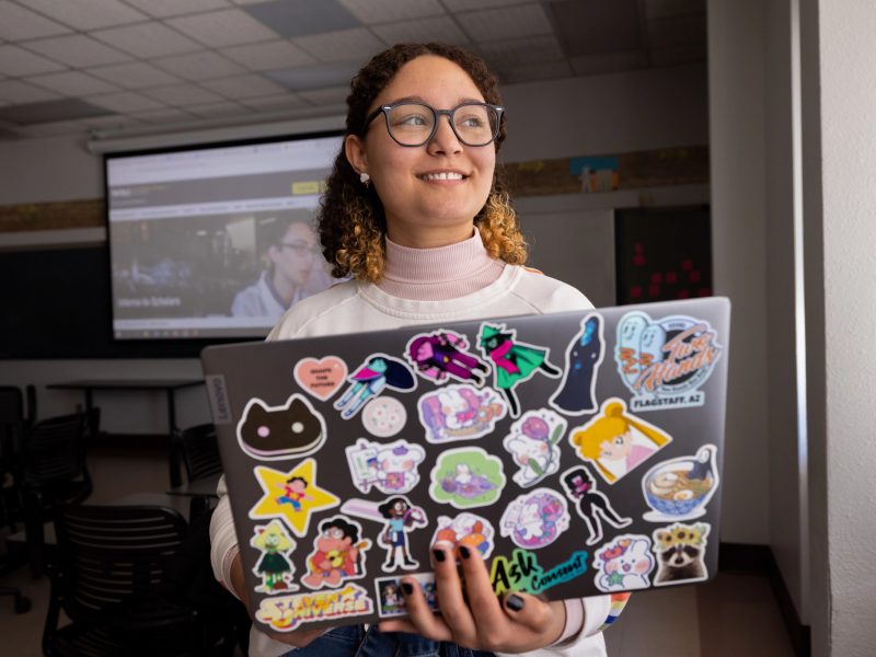 Student holding a laptop.