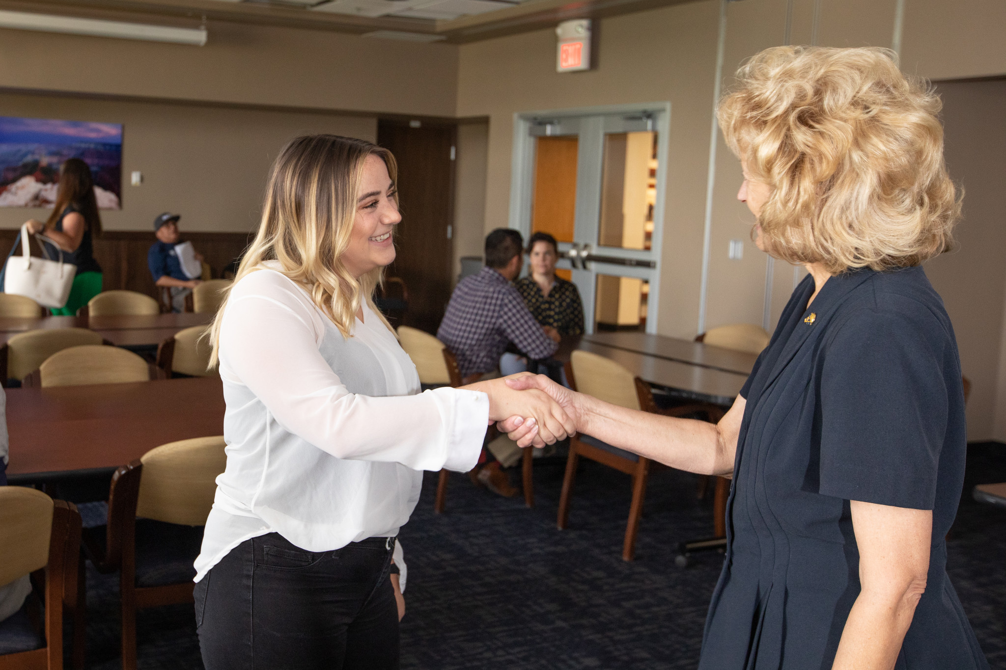 N A U student speaking with a professor in a working session enviroment.