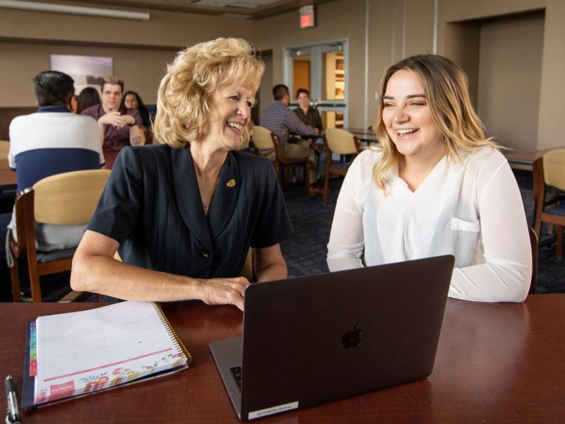 Alumni speaking with each other.