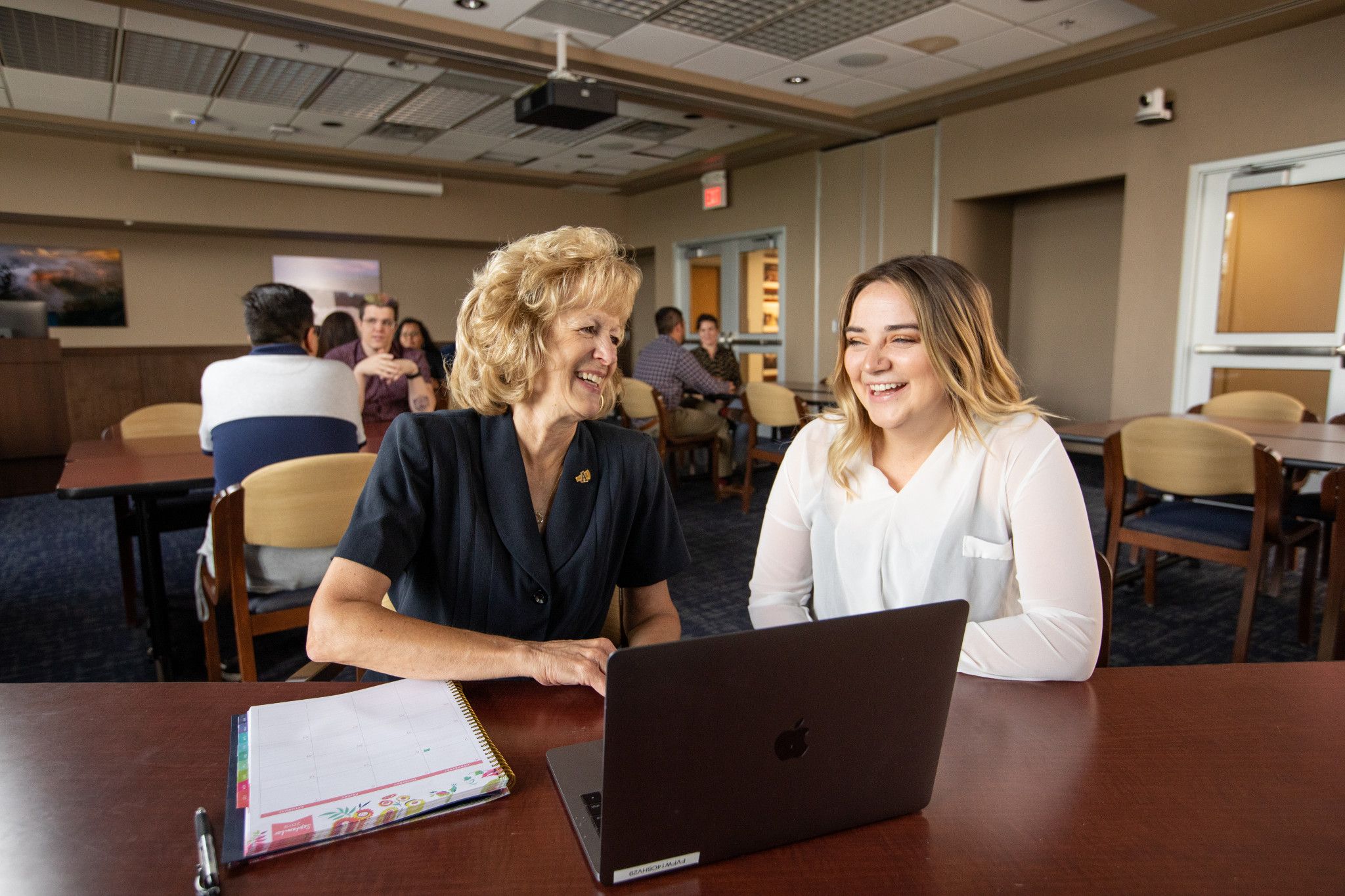 Alumni speaking with each other.