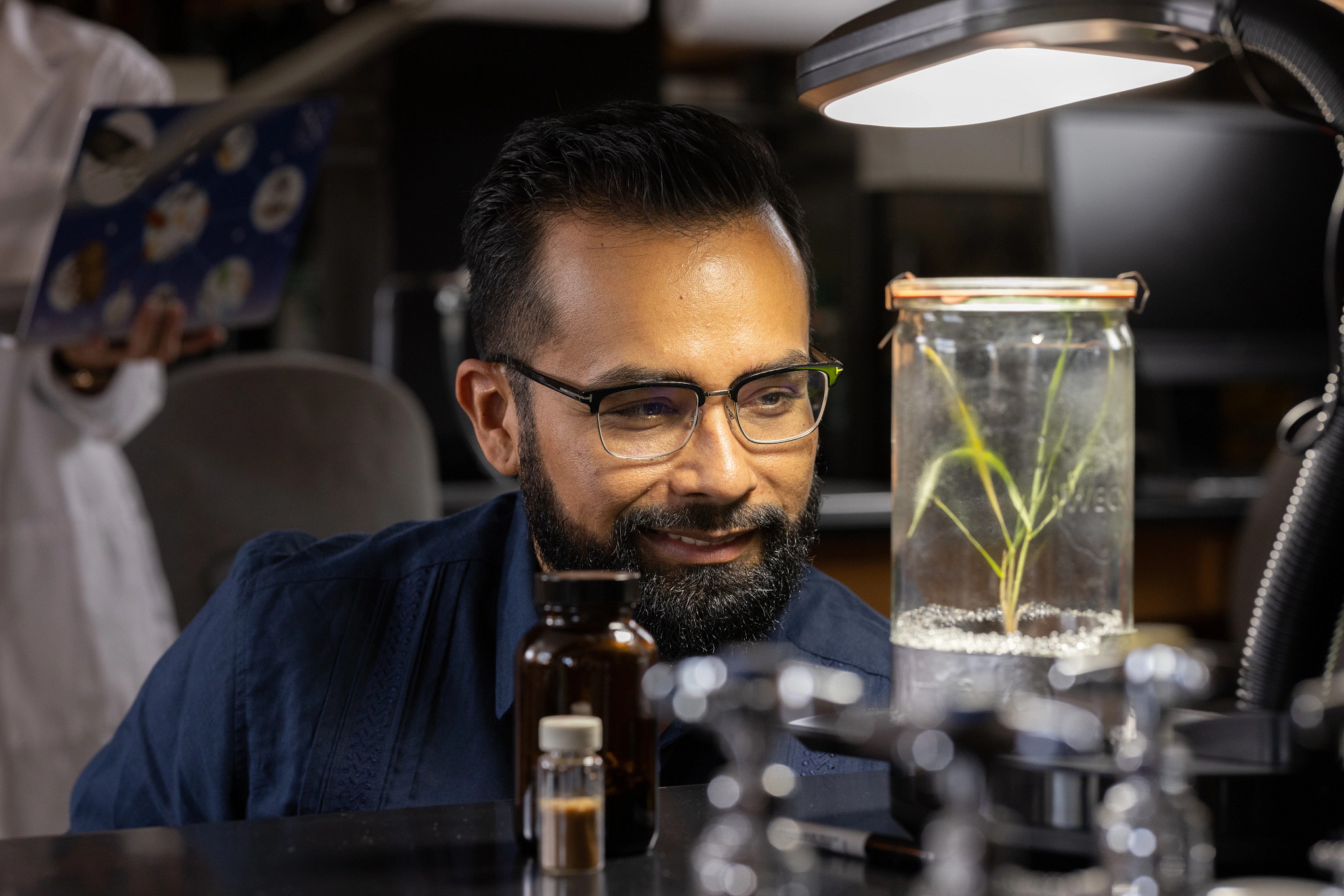 N A U faculty looking at a test sample jar.