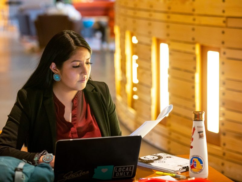 N A U faculty working with a moody light in the background.