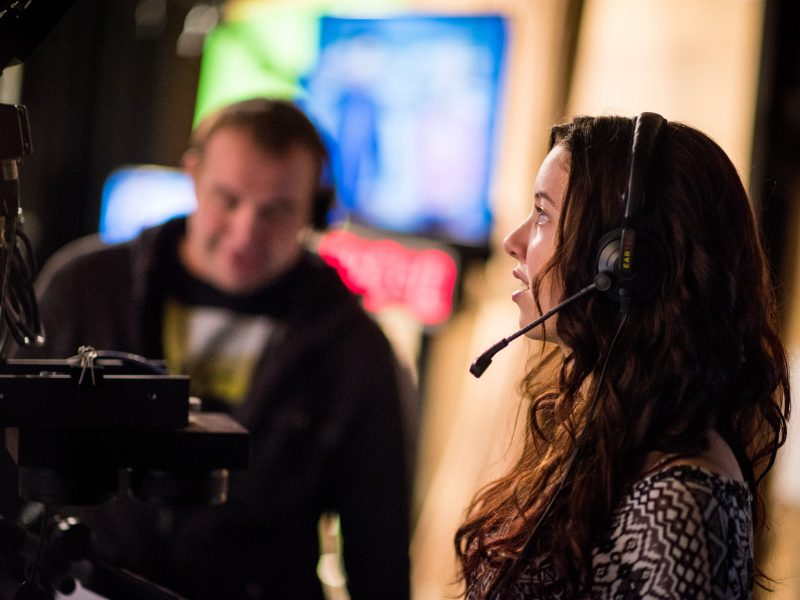 N A U student wearing a headset and operating a production camera.
